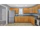 This kitchen features wood cabinets, stainless steel appliances, and a double sink at 2414 N Blaine St, Muncie, IN 47303