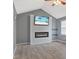 Bright living room featuring a fireplace, TV, and ceiling fan at 2414 N Blaine St, Muncie, IN 47303