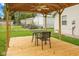 Pergola with table and chairs on wood deck and ceiling fan with view of the siding house in backyard at 2414 N Blaine St, Muncie, IN 47303