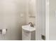 Small bathroom with a pedestal sink, toilet, and a half-view of the shower at 2417 N Rural N Ave, Indianapolis, IN 46218