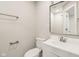 Modern bathroom with white vanity, sink, toilet, and a framed mirror at 2417 N Rural N Ave, Indianapolis, IN 46218