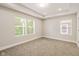 Spacious bedroom featuring large windows, neutral carpeting, and a trey ceiling at 2417 N Rural N Ave, Indianapolis, IN 46218