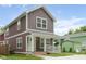 Inviting two-story home with brown siding, a white trim front porch, and a well-kept lawn at 2417 N Rural N Ave, Indianapolis, IN 46218
