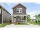 Charming two-story home with brown siding, white trim, front porch, and well-maintained yard at 2417 N Rural N Ave, Indianapolis, IN 46218