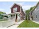 Well-maintained two-story home with brown siding, white trim, covered front porch, and manicured lawn at 2417 N Rural N Ave, Indianapolis, IN 46218
