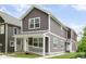 Attractive two-story home with brown siding, white trim, covered front porch, and landscaped surroundings at 2417 N Rural N Ave, Indianapolis, IN 46218