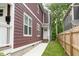 Side view of a two-story home with brown siding, white trim, front entrance, and a landscaped yard at 2417 N Rural N Ave, Indianapolis, IN 46218