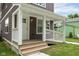 Cozy front porch featuring white railings, wood steps, and a charming entrance to the home at 2417 N Rural N Ave, Indianapolis, IN 46218