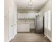 Bright kitchen with an island, stainless steel refrigerator, and wood-look floors at 2417 N Rural N Ave, Indianapolis, IN 46218
