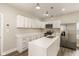 Elegant kitchen equipped with white cabinets, stainless steel appliances, a center island, and modern lighting at 2417 N Rural N Ave, Indianapolis, IN 46218