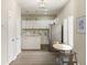 Bright kitchen and dining area with stainless steel refrigerator and island with sink at 2417 N Rural N Ave, Indianapolis, IN 46218