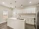 Contemporary kitchen featuring white cabinetry, stainless steel appliances, a central island, and wood flooring at 2417 N Rural N Ave, Indianapolis, IN 46218