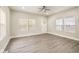 Living room with three windows providing natural light and modern wood-look flooring at 2417 N Rural N Ave, Indianapolis, IN 46218
