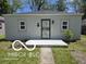 Charming home exterior with a freshly painted facade, a secure front door, and manicured landscaping at 2421 N Arsenal Ave, Indianapolis, IN 46218