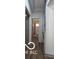 Narrow hallway view with wood floors leading to a bathroom with shower at 2421 N Arsenal Ave, Indianapolis, IN 46218