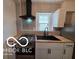 Close-up of modern kitchen features new stainless steel stove and black sink at 2421 N Arsenal Ave, Indianapolis, IN 46218