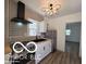 Modern kitchen features new stainless steel appliances, gray backsplash, and dark sink at 2421 N Arsenal Ave, Indianapolis, IN 46218