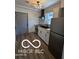 Modern kitchen features new stainless steel appliances, a gray tile backsplash, and sleek countertops at 2421 N Arsenal Ave, Indianapolis, IN 46218