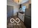Modern kitchen features new stainless steel appliances, a gray tile backsplash, and sleek countertops at 2421 N Arsenal Ave, Indianapolis, IN 46218