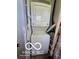 Efficient laundry area with a stacked washer and dryer unit and functional utility connections at 2421 N Arsenal Ave, Indianapolis, IN 46218