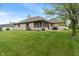 A spacious backyard with a patio, screened-in porch and well-manicured lawn at 2422 Oak Dr, Clayton, IN 46118
