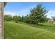 Large, green backyard features a well-manicured lawn and mature trees at 2422 Oak Dr, Clayton, IN 46118