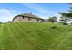 Spacious backyard features a well-manicured lawn leading to a brick home at 2422 Oak Dr, Clayton, IN 46118