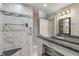 Bathroom featuring a sink, vanity, mirror, walk in shower and white and grey tiling at 2422 Oak Dr, Clayton, IN 46118