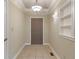 Inviting entrance hall featuring tile flooring, neutral paint, and decorative lighting at 2422 Oak Dr, Clayton, IN 46118