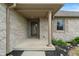 Covered front porch with brick columns and a decorative storm door at 2422 Oak Dr, Clayton, IN 46118