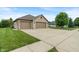 Spacious driveway leading to a three-car garage, surrounded by a lush green lawn at 2422 Oak Dr, Clayton, IN 46118