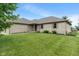Well-maintained brick home with manicured lawn and garden beds in a suburban neighborhood at 2422 Oak Dr, Clayton, IN 46118