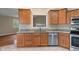 Kitchen featuring wooden cabinets, granite countertops, and stainless steel dishwasher at 2422 Oak Dr, Clayton, IN 46118