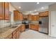 Well-lit kitchen featuring wooden cabinets, granite countertops, and stainless steel appliances at 2422 Oak Dr, Clayton, IN 46118
