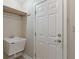 Laundry room with utility sink, storage and adjacent door at 2422 Oak Dr, Clayton, IN 46118