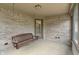 Enclosed porch featuring a wooden swing and a door leading to the backyard at 2422 Oak Dr, Clayton, IN 46118