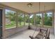 Enclosed porch featuring a wooden swing and large windows with views of the backyard at 2422 Oak Dr, Clayton, IN 46118