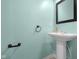 Powder room showcasing a pedestal sink with a framed mirror and sleek hardware at 2502 Creekland Dr, Columbus, IN 47201