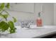 Bathroom sink with white countertop, modern faucet, and decorative soap dispenser at 2502 Creekland Dr, Columbus, IN 47201