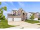 This two story home includes a two car garage, brick facade, large driveway and manicured lawn at 2502 Creekland Dr, Columbus, IN 47201