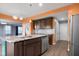 Bright kitchen features an island with granite countertops, stainless steel appliances, and stylish dark cabinets at 2502 Creekland Dr, Columbus, IN 47201