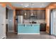 Open kitchen with a central island, stainless steel appliances, dark cabinetry, and colorful accent wall at 2502 Creekland Dr, Columbus, IN 47201