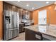 This gourmet kitchen features a stainless steel refrigerator, granite countertops, and abundant cabinet space at 2502 Creekland Dr, Columbus, IN 47201