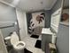 Bathroom with toilet and sink, featuring assistive hand rails at 3041 S Rybolt Ave, Indianapolis, IN 46241