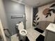 Bathroom featuring a toilet with assistive hand rail and tiled floors at 3041 S Rybolt Ave, Indianapolis, IN 46241