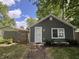 Charming bungalow with gray siding, white trim, landscaped flower bed, and a well-manicured lawn at 3041 S Rybolt Ave, Indianapolis, IN 46241
