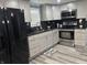 Kitchen featuring stainless steel appliances, dark countertops, and gray cabinets at 3041 S Rybolt Ave, Indianapolis, IN 46241