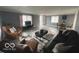 Spacious living room with grey walls, wood floors, an area rug, and ample seating at 3041 S Rybolt Ave, Indianapolis, IN 46241