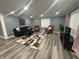 Bright living room with wood flooring, a patterned rug, and dark furniture at 3041 S Rybolt Ave, Indianapolis, IN 46241
