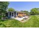 Wide backyard with a screened porch, patio furniture, and a grill, perfect for outdoor entertaining and relaxation at 3105 E Banta Rd, Indianapolis, IN 46227